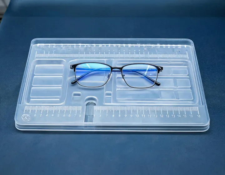 Blue light reading glasses on a sizing tray with a millimeter ruler